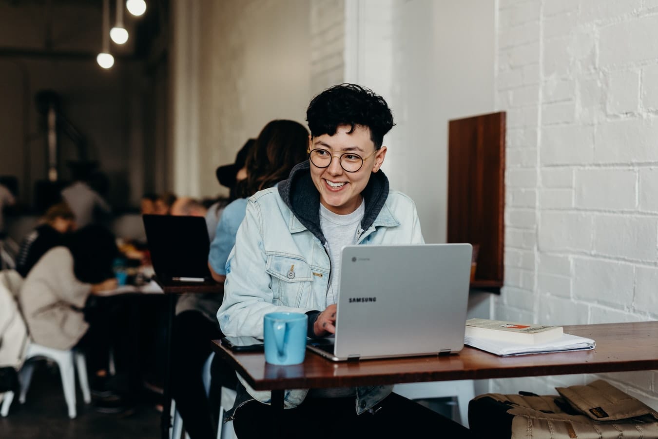 person smilig while using laptop